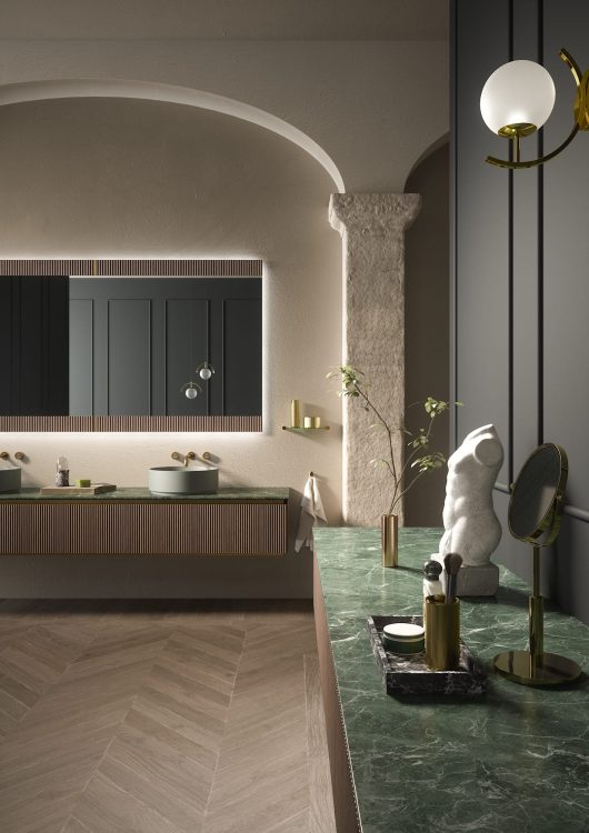 Nàos vanity unit in ribbed Walnut finish/Satin gold. Top in Verde Alpi marble 
